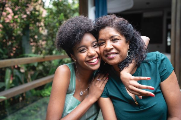 Smiling women embracing outdoors