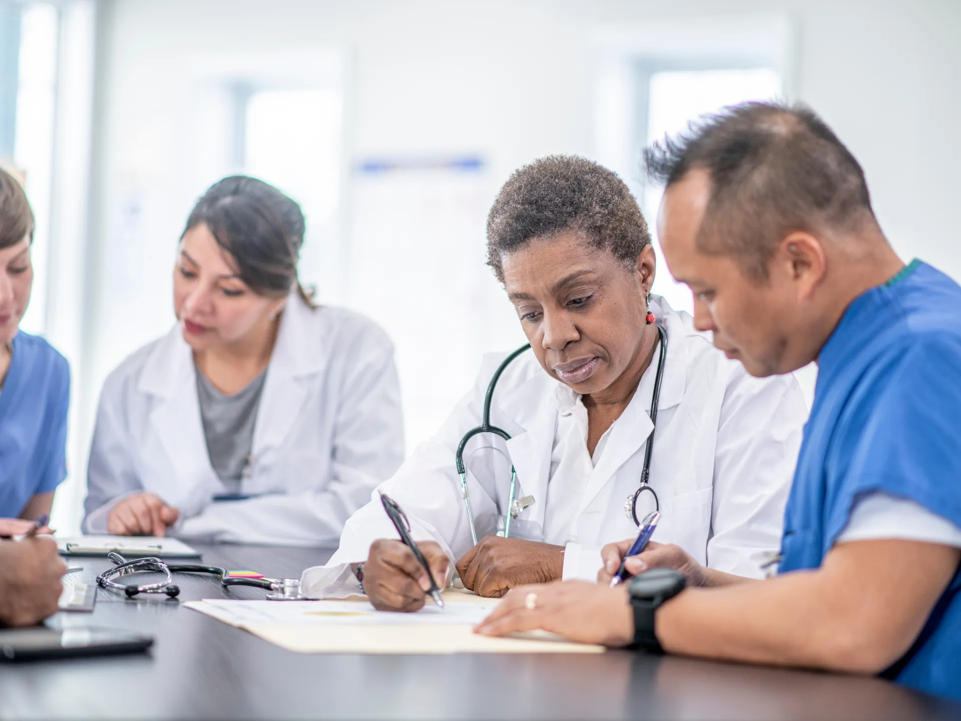Doctors discussing MELD and PELD scores